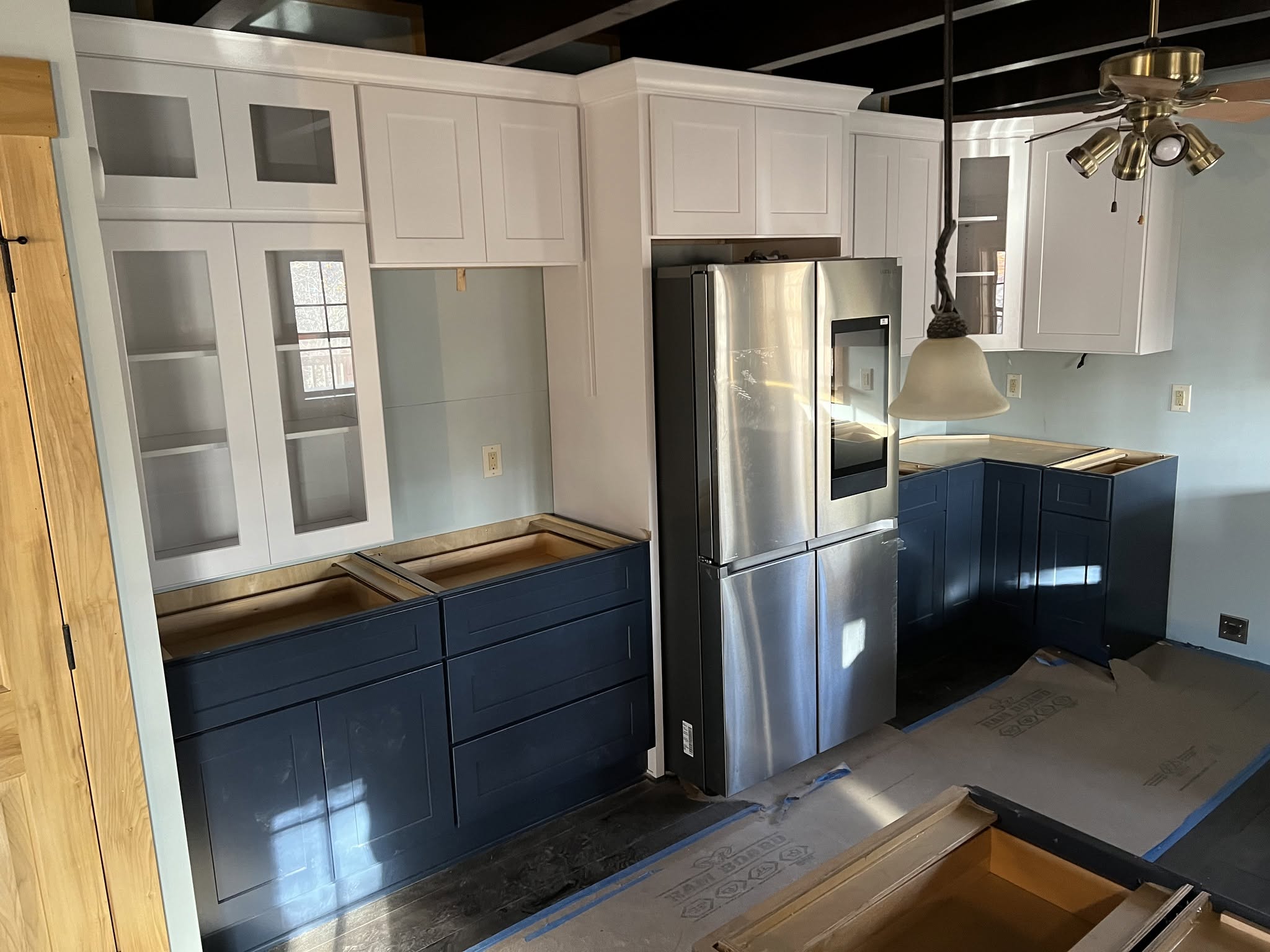 Custom kitchen with navy lower cabinets and white upper cabinets