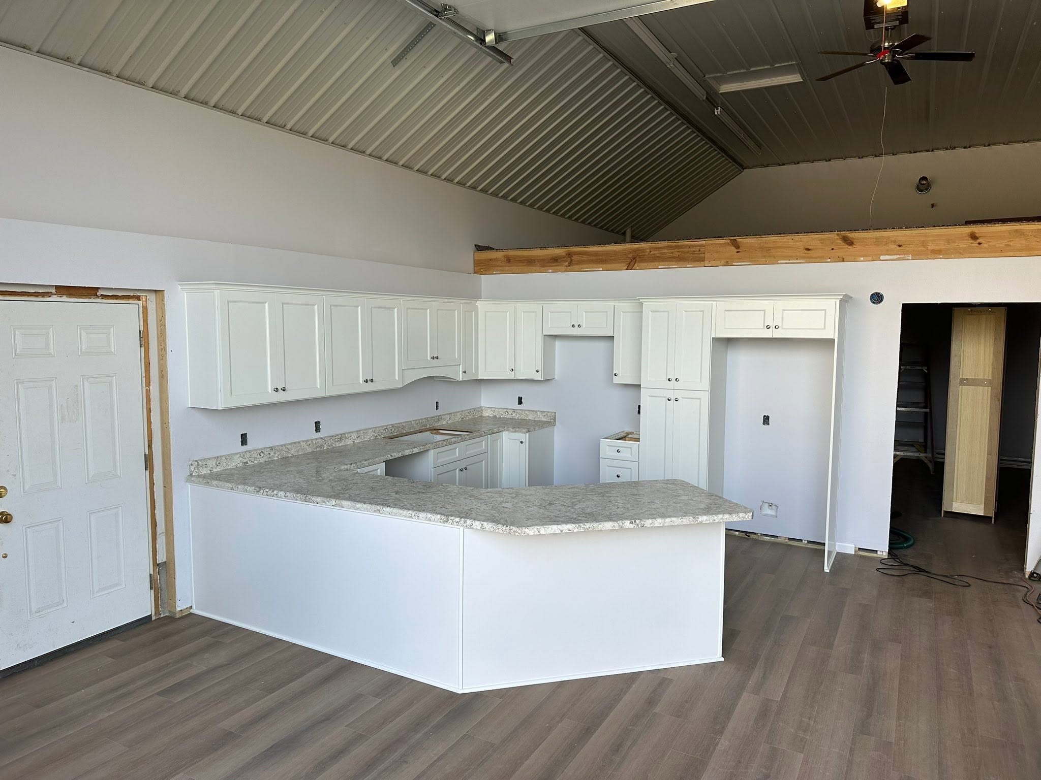 Large white cabinet installation with wraparound worktop